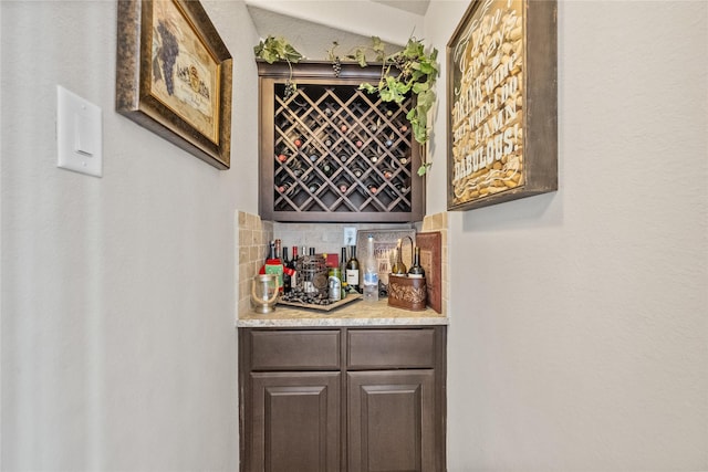 bar featuring a bar and decorative backsplash