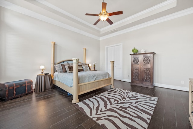 bedroom featuring wood-type flooring, visible vents, a tray ceiling, and crown molding