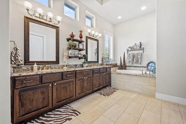 bathroom featuring double vanity, a sink, and a bath