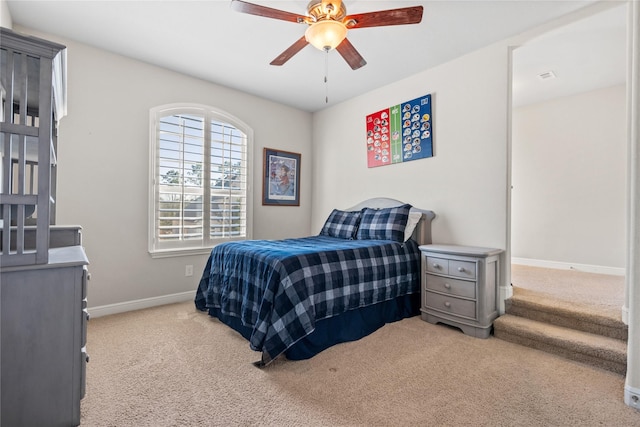 carpeted bedroom featuring visible vents, baseboards, and a ceiling fan