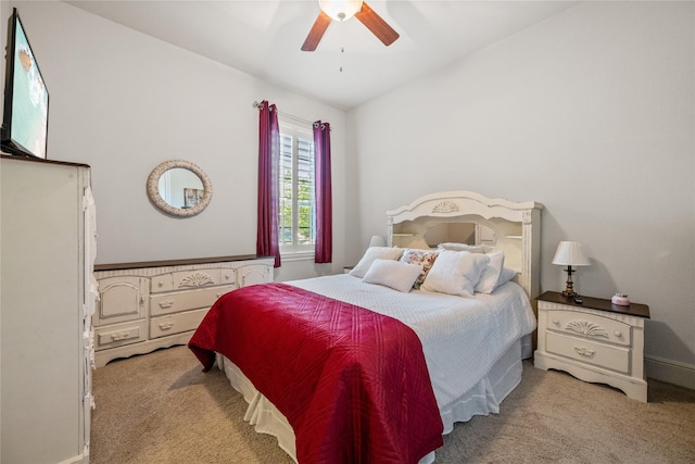 carpeted bedroom featuring vaulted ceiling and ceiling fan