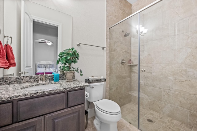 full bath with tiled shower, vanity, and toilet