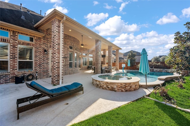 view of pool featuring ceiling fan, a patio, fence, and a pool with connected hot tub