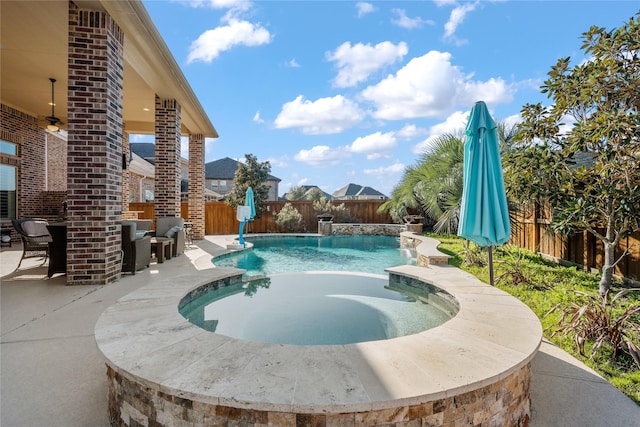 view of swimming pool featuring a patio area, a fenced backyard, a fenced in pool, and a hot tub