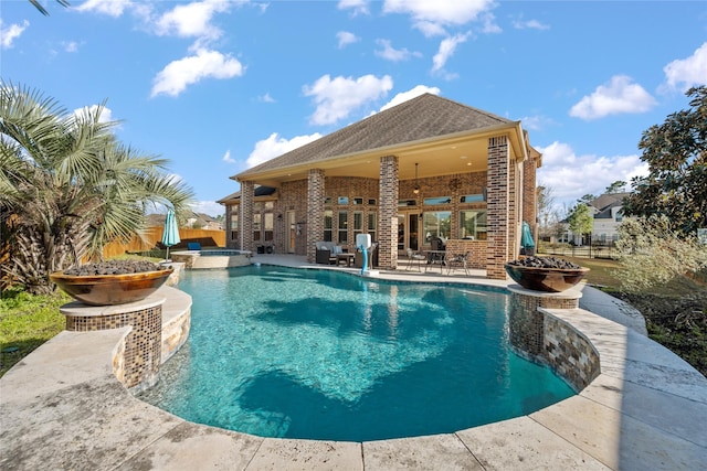 view of pool featuring a pool with connected hot tub and a patio