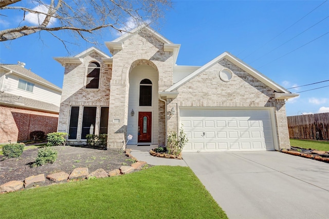 view of front of house featuring brick siding, concrete driveway, a front yard, fence, and a garage