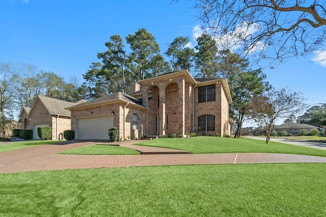 view of front facade with a garage, driveway, a front yard, and brick siding