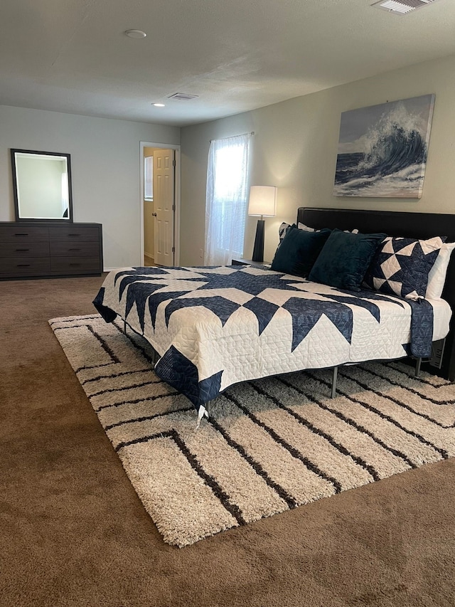 carpeted bedroom with visible vents