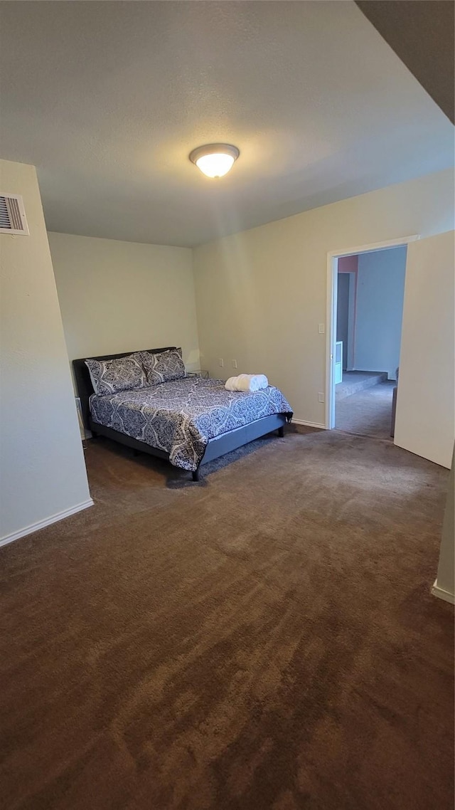 unfurnished bedroom featuring carpet, visible vents, and baseboards