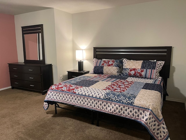 bedroom featuring carpet and baseboards