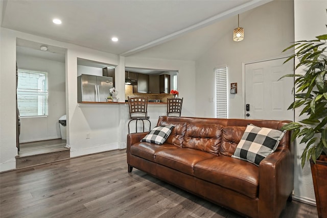 living room with vaulted ceiling, baseboards, wood finished floors, and recessed lighting