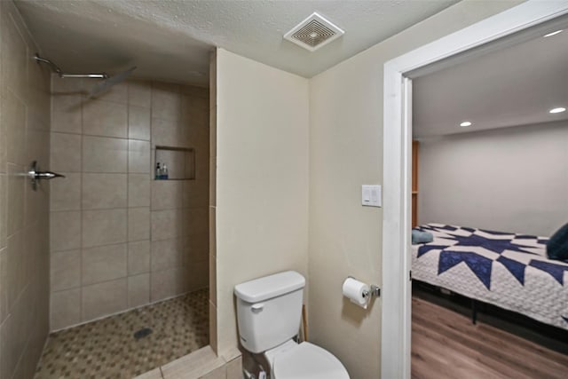 bathroom with toilet, ensuite bath, a tile shower, and visible vents