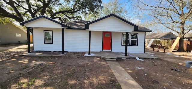 view of front of home featuring fence