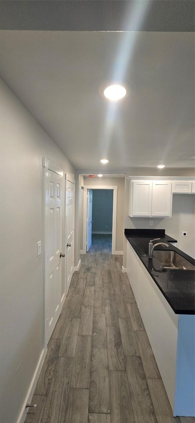 716 Alamo St, Rosenberg, TX 77471 - hall with a sink, dark wood-style floors, baseboards, and recessed lighting