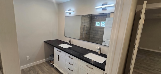 716 Alamo St, Rosenberg, TX 77471 - full bath featuring wood finished floors, baseboards, double vanity, and tiled shower