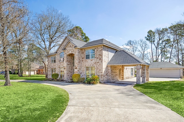 view of front of home featuring a shingled roof, an outbuilding, brick siding, and a front lawn