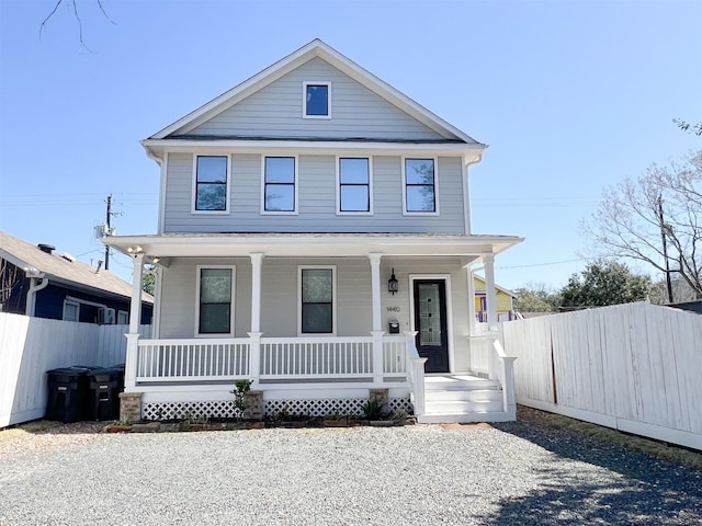 view of front facade featuring a porch and fence