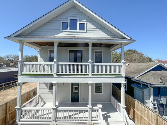 back of house with a porch and fence