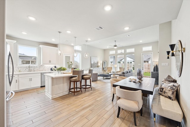 dining room with recessed lighting, visible vents, ceiling fan, and light wood finished floors