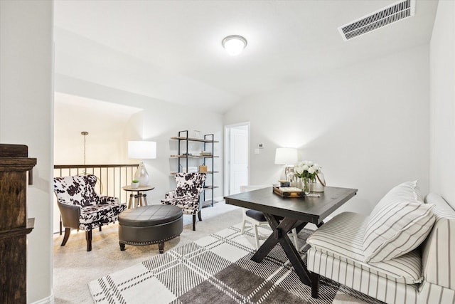 office featuring vaulted ceiling, visible vents, and light carpet