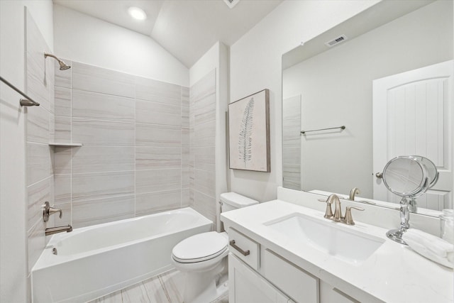 full bathroom with visible vents, toilet, shower / bathing tub combination, lofted ceiling, and vanity