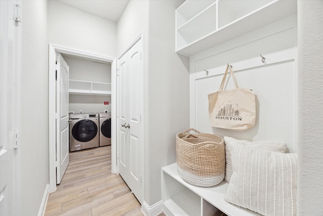 mudroom featuring wood finished floors and washer and clothes dryer