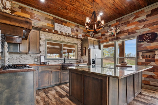 kitchen featuring tasteful backsplash, wood ceiling, stainless steel appliances, and dark wood-type flooring