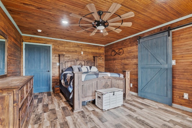 unfurnished bedroom featuring a barn door, wood ceiling, wood finished floors, crown molding, and wood walls