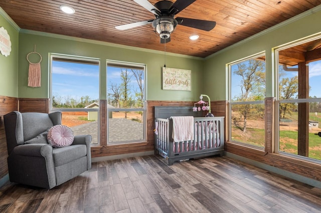 sunroom with a ceiling fan and wooden ceiling