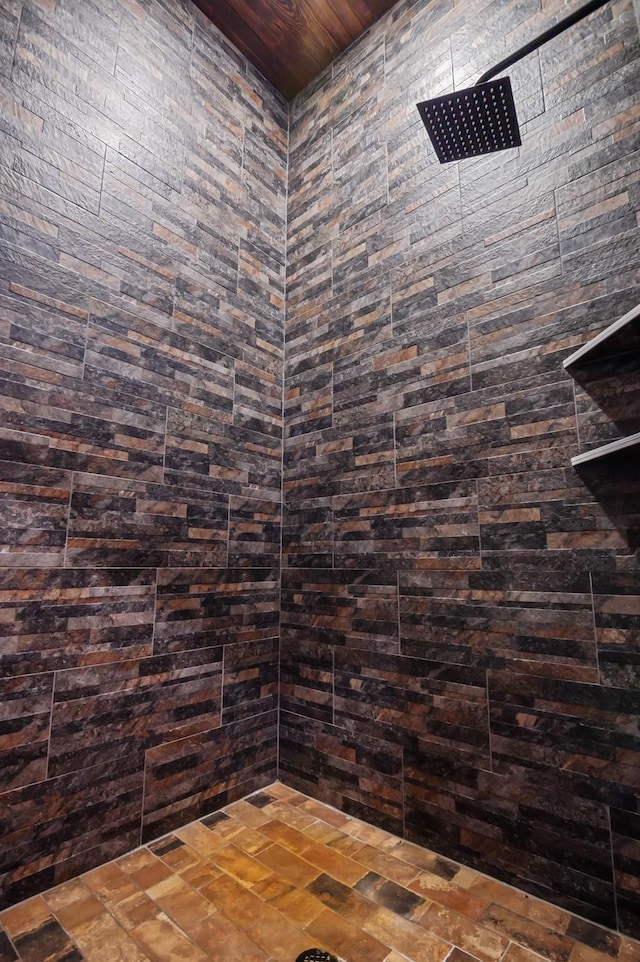 interior details featuring tiled shower