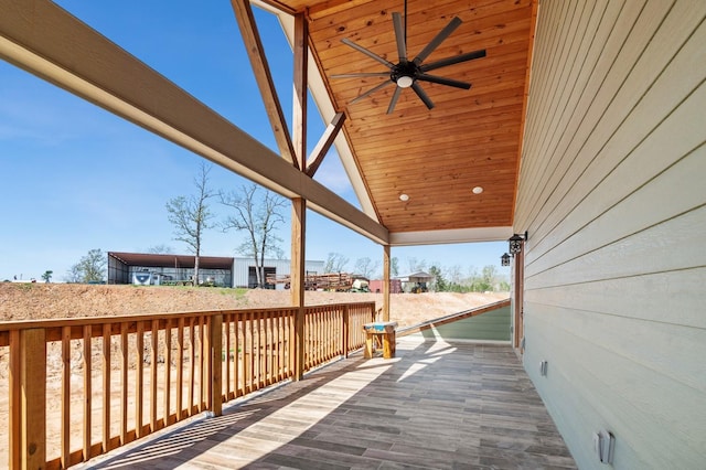 wooden deck with a ceiling fan