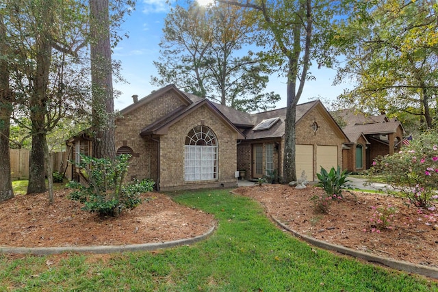 ranch-style house featuring a garage, concrete driveway, fence, a front lawn, and brick siding