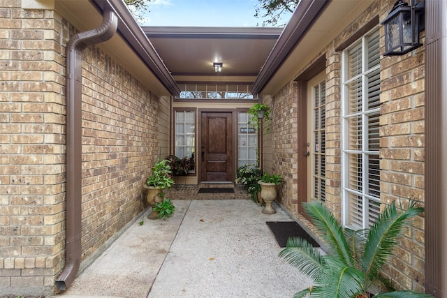 doorway to property with brick siding