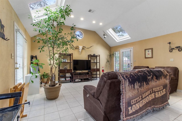 tiled living area with lofted ceiling with skylight, visible vents, and recessed lighting