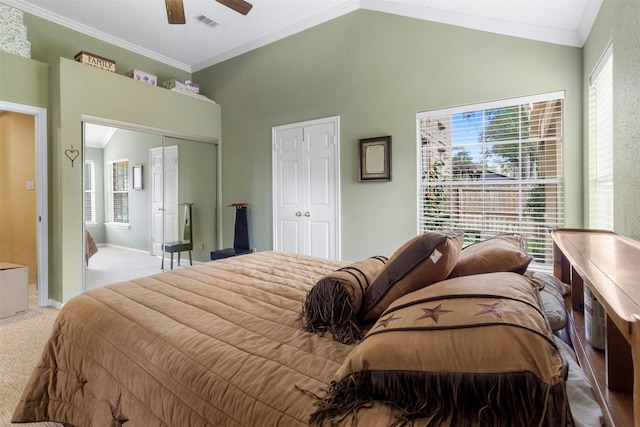 carpeted bedroom with vaulted ceiling, baseboards, visible vents, and crown molding