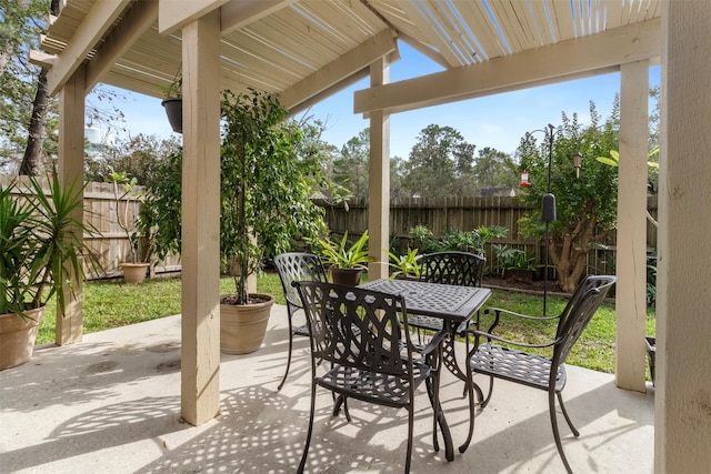 view of patio / terrace featuring fence and outdoor dining area