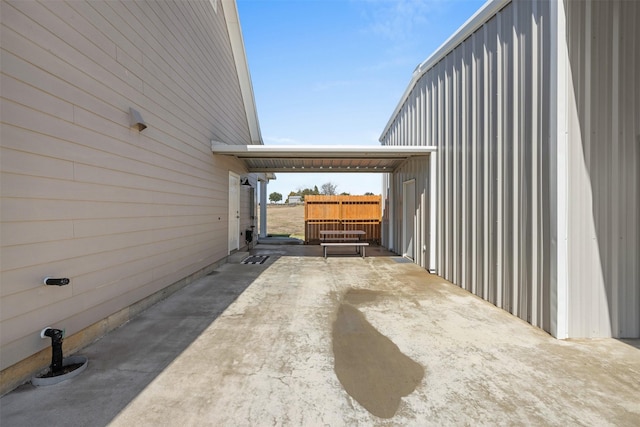 view of patio / terrace with driveway and a carport