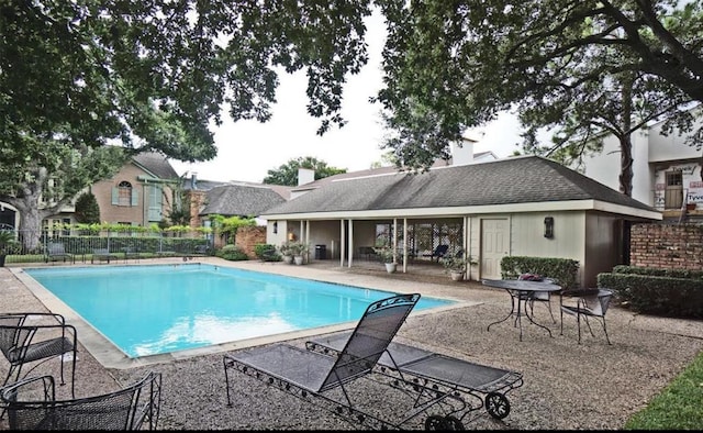 pool featuring a patio area and fence