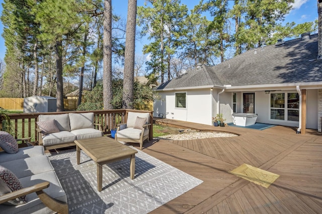 deck featuring a storage shed, fence, outdoor lounge area, and an outdoor structure