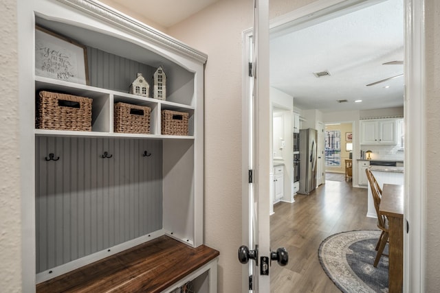 mudroom featuring visible vents and wood finished floors