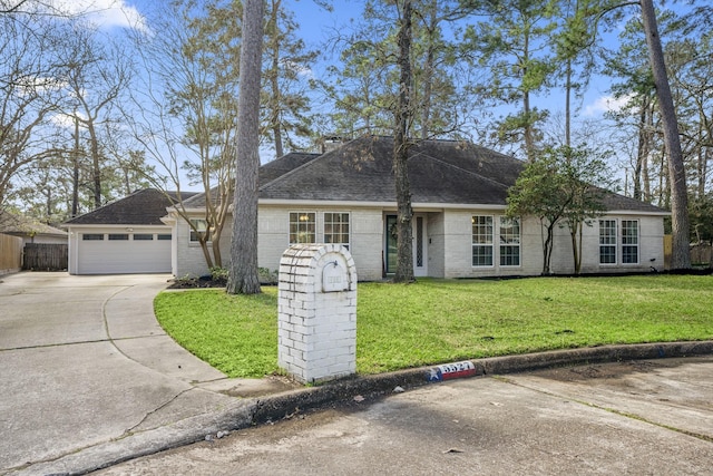 single story home featuring brick siding, roof with shingles, concrete driveway, a front yard, and fence