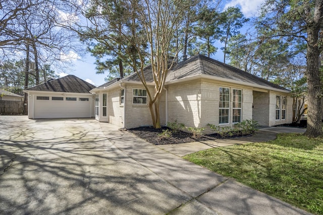 single story home featuring driveway, brick siding, an attached garage, and fence