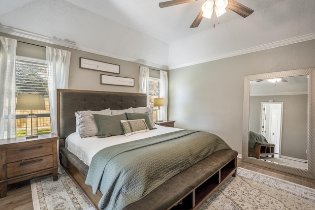 bedroom featuring baseboards, ceiling fan, ornamental molding, and wood finished floors