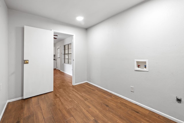 empty room with baseboards and wood finished floors