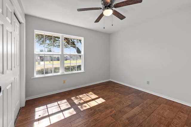 spare room featuring a ceiling fan, baseboards, and wood finished floors