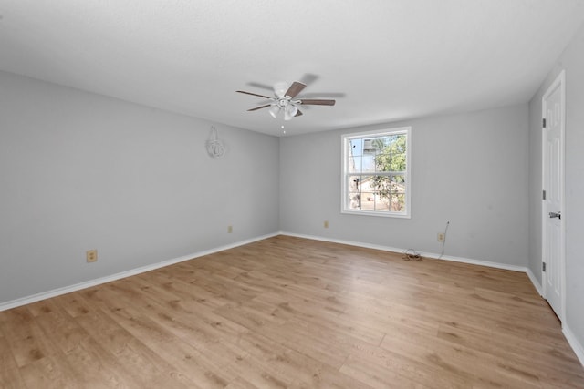 empty room featuring light wood-style flooring, baseboards, and a ceiling fan