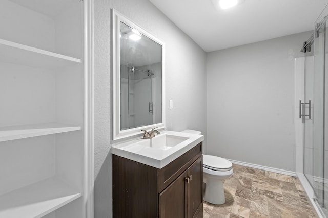 full bath featuring toilet, a stall shower, baseboards, and vanity