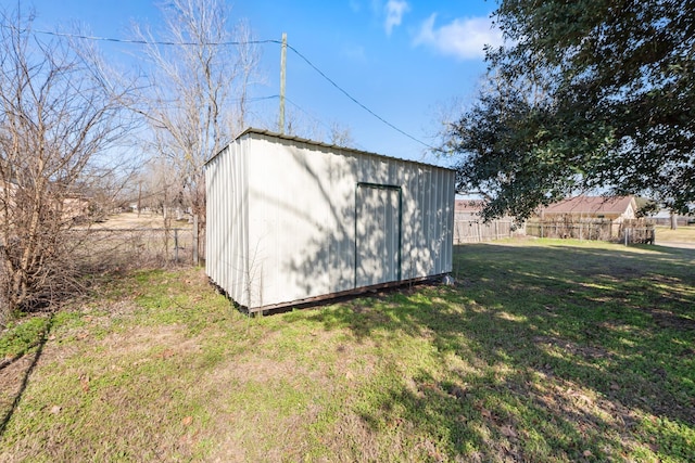 view of shed featuring fence