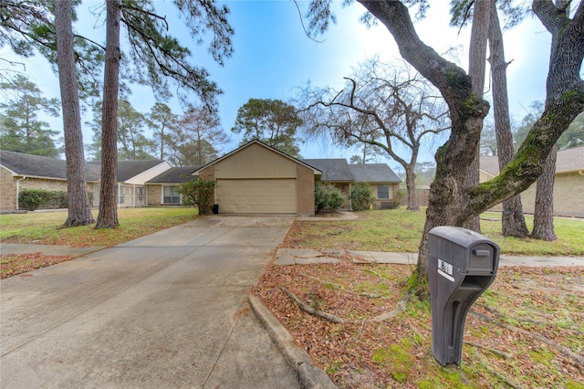 view of front facade featuring an attached garage, a front lawn, concrete driveway, and brick siding