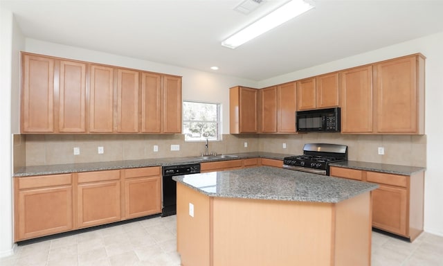 kitchen featuring a sink, visible vents, decorative backsplash, a center island, and black appliances